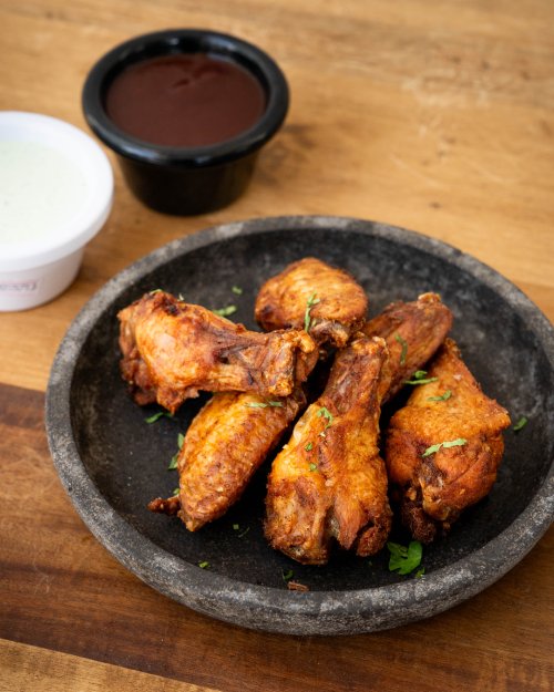Crispy chicken wings tossed in sauce